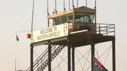An armoured vehicle passes a watchtower at Bastion Airfield at Camp Bastion on December 7, 2010 in Helmand Province, Afghanistan.