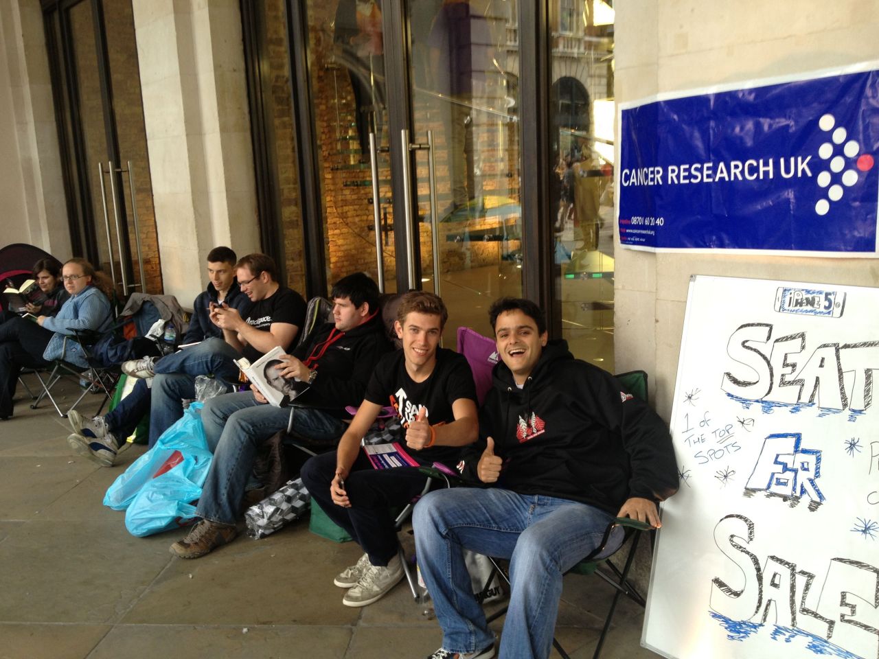Alexandre Marchetti walked by the Apple store in London's Covent Garden on Thursday and <a href="http://ireport.cnn.com/docs/DOC-844355">shot this photo</a> of a man offering a seat for sale at the front of the iPhone 5 line to raise money for cancer research. It's going for 600 pounds, or nearly $1,000 U.S. dollars. The man has been waiting since Friday.