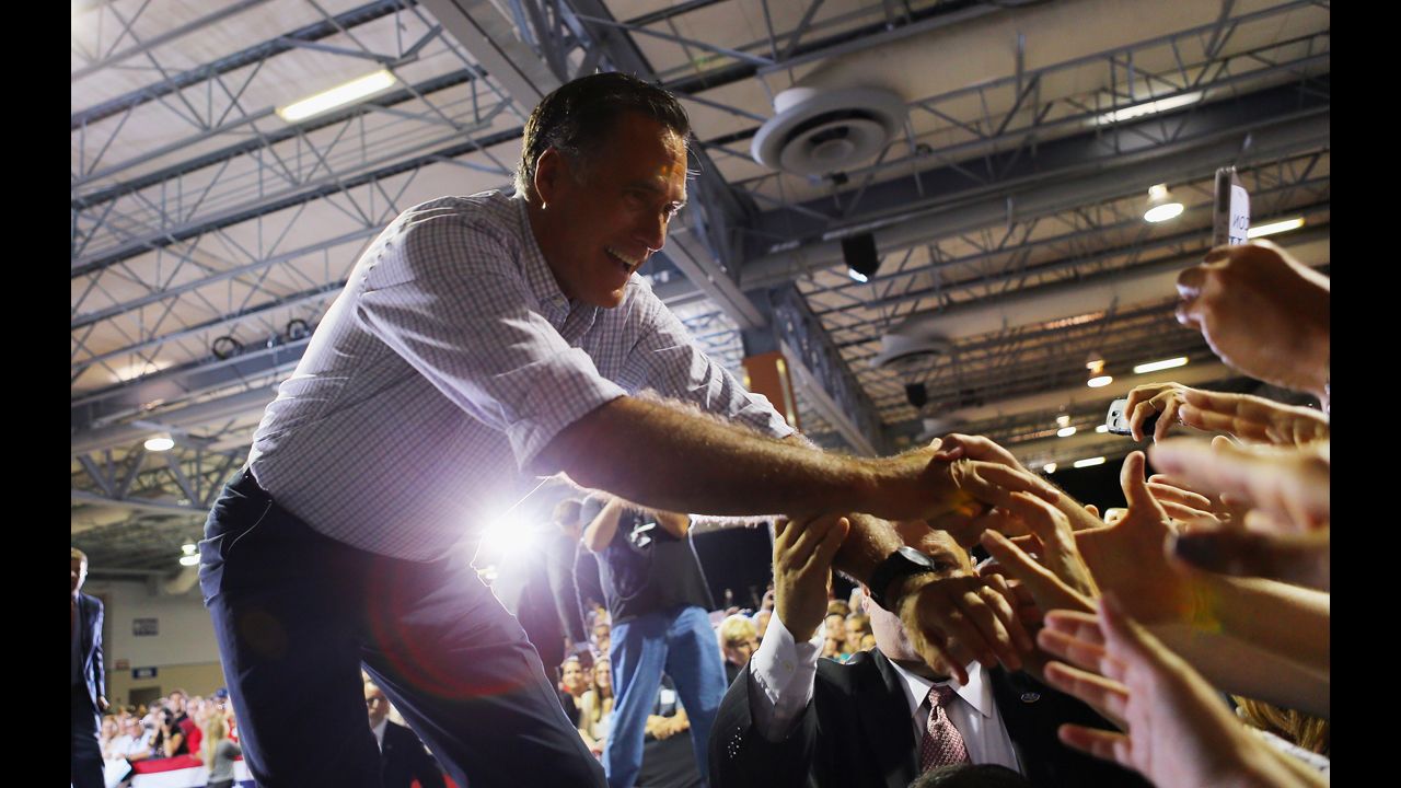 Republican presidential candidate Mitt Romney shakes hands with supporters during a Juntos Con Romney Rally at the Darwin Fuchs Pavilion on Wednesday, September 19, in Miami.
