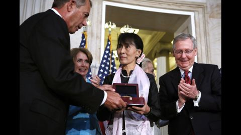 Burmese opposition politician Aung San Suu Kyi, center, is presented with a U.S. Congressional Gold Medal by Speaker of the House John Boehner, left, as House Minority Leader Nancy Pelosi, second left, and Senate Minority Leader Mitch McConnell, right, look on during a presentation ceremony at the Rotunda of the U.S. Capitol on Wednesday in Washington. Aung San Suu Kyi was presented with the medal for her leadership and commitment to human rights and for promoting freedom, peace and democracy in Myanmar, also known as Burma. 