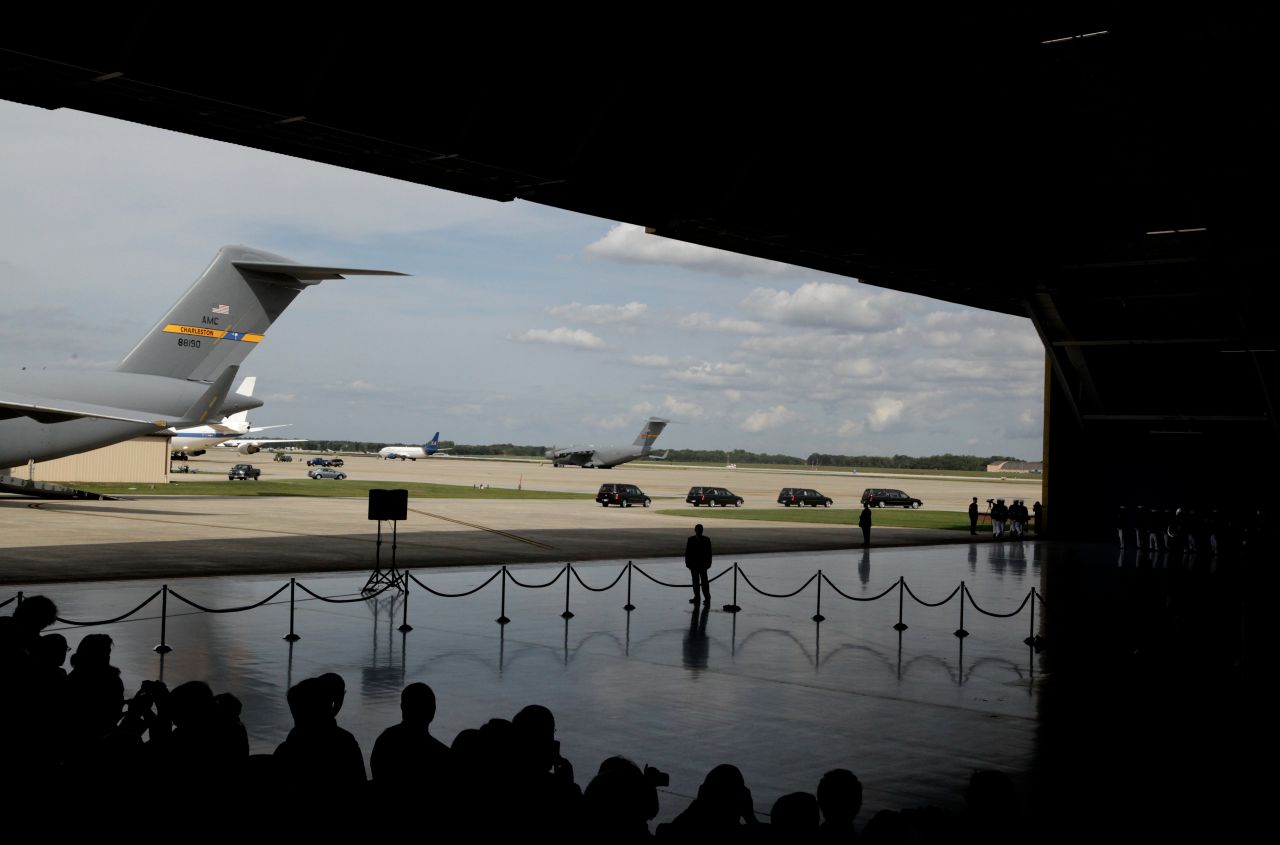 Four hearses carrying caskets leave the hangar during the Transfer of Remains Ceremony for the return of the four Libyan embassy employees on Friday at Joint Base Andrews, Maryland.