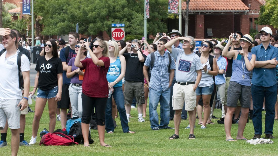 Students and faculty at the University of Arizona watch as Endeavour flies over the campus in Tucson, Arizona, on Thursday. Endeavour reportedly flew over Tucson to honor former Arizona Rep. Gabrielle Giffords and her husband, retired astronaut Mark Kelly, who commanded Endeavour's final mission to space in May 2011.