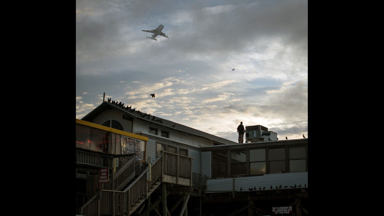 Endeavour is flown over the pier in Cocoa Beach, Florida, on Wednesday. 
