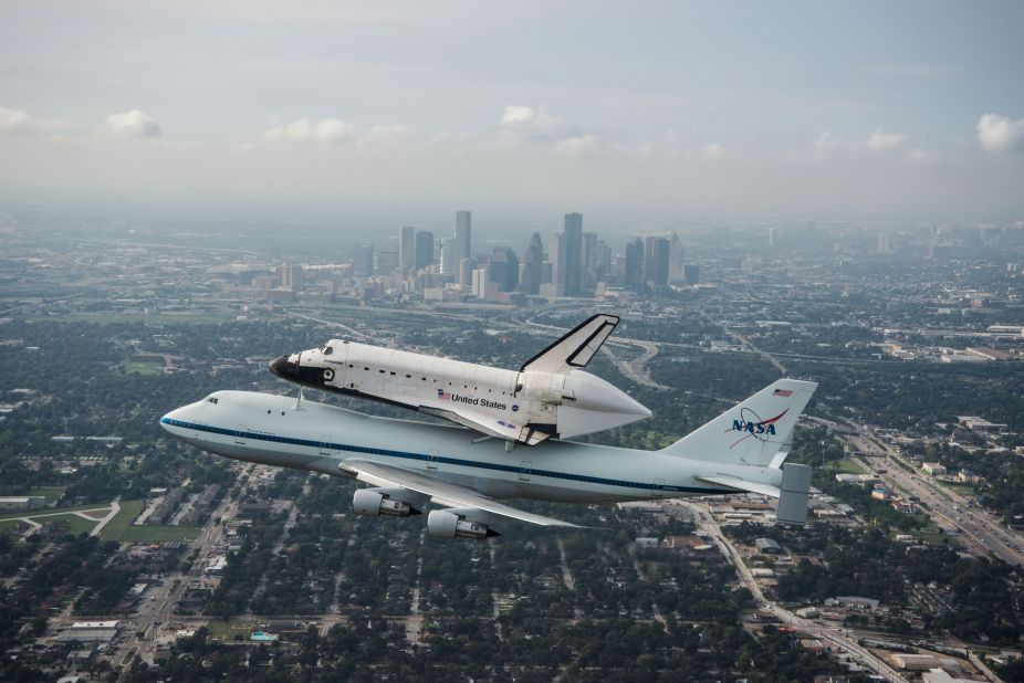 Space shuttle Endeavour is ferried by NASA's shuttle carrier aircraft as it flies over Houston on Wednesday, September 19. After a two-day delay due to unfavorable weather, Endeavour began its flight to Los Angeles on Wednesday.