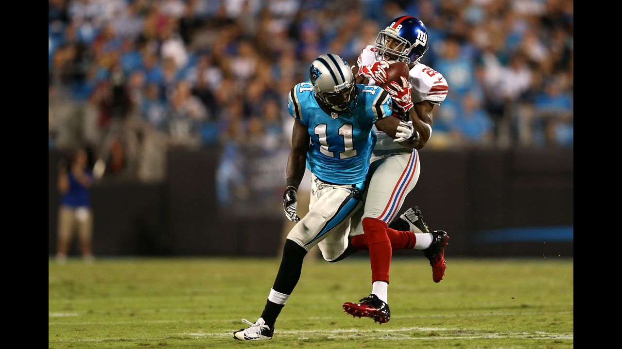 Jayron Hosley of the New York Giants intercepts a pass intended for Brandon LaFell of the Carolina Panthers on Thursday.