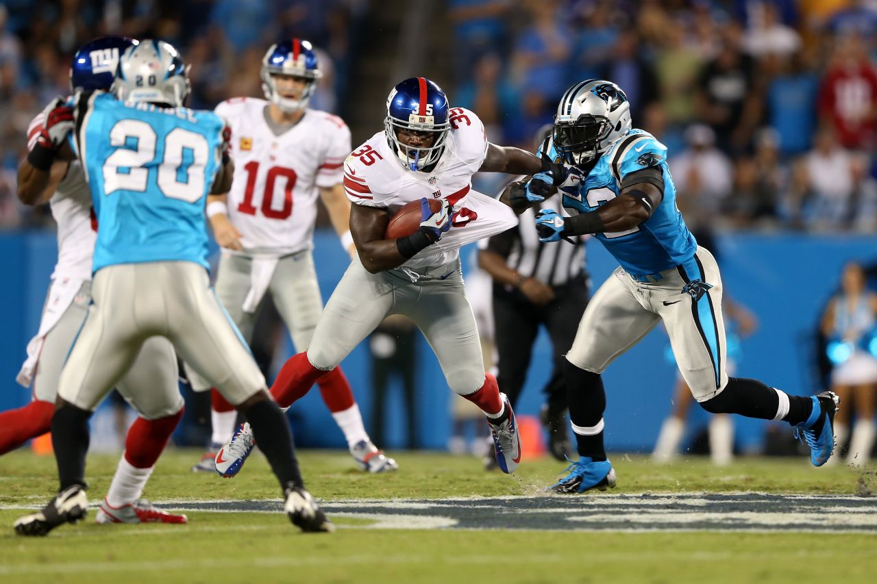 Andre Brown of the New York Giants runs the ball in the first quarter against the Carolina Panthers on Thursday.