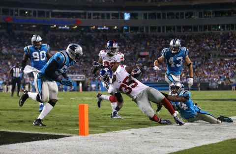 Andre Brown of the Giants runs the ball down to the 2-yard line in the second quarter on Thursday against  Josh Norman of the Carolina Panthers.