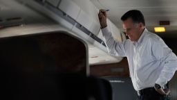 US Republican presidential candidate Mitt Romney speaks to an aide aboard his campaign plane as he heads to Las Vegas, Nevada on September 21, 2012. AFP PHOTO/Nicholas KAMM (Photo credit should read NICHOLAS KAMM/AFP/GettyImages) 