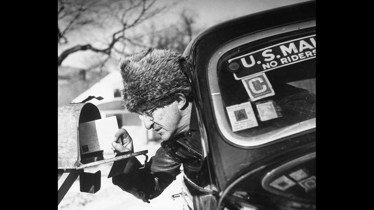 Life.com pays tribute to mail carriers, other postal workers and the U.S. Postal Service in earlier times. Here, a rural Vermont mail carrier makes his rounds in subzero weather.