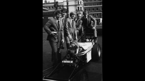 The Beach Boys pose around a dragster in London's West End during a visit to England in 1964 to promote their new single 'When I Grow Up" in November 1964