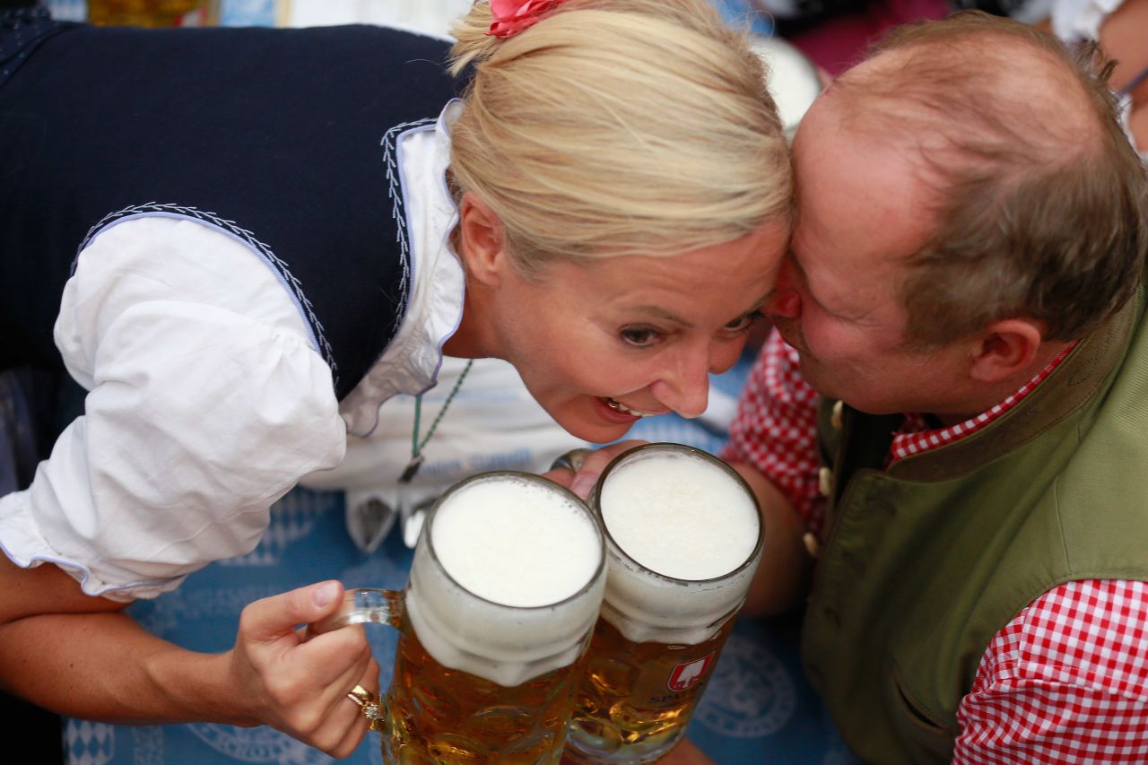 German actor Axel Milberg and his wife, Judith, cheer with beer mugs on Saturday.