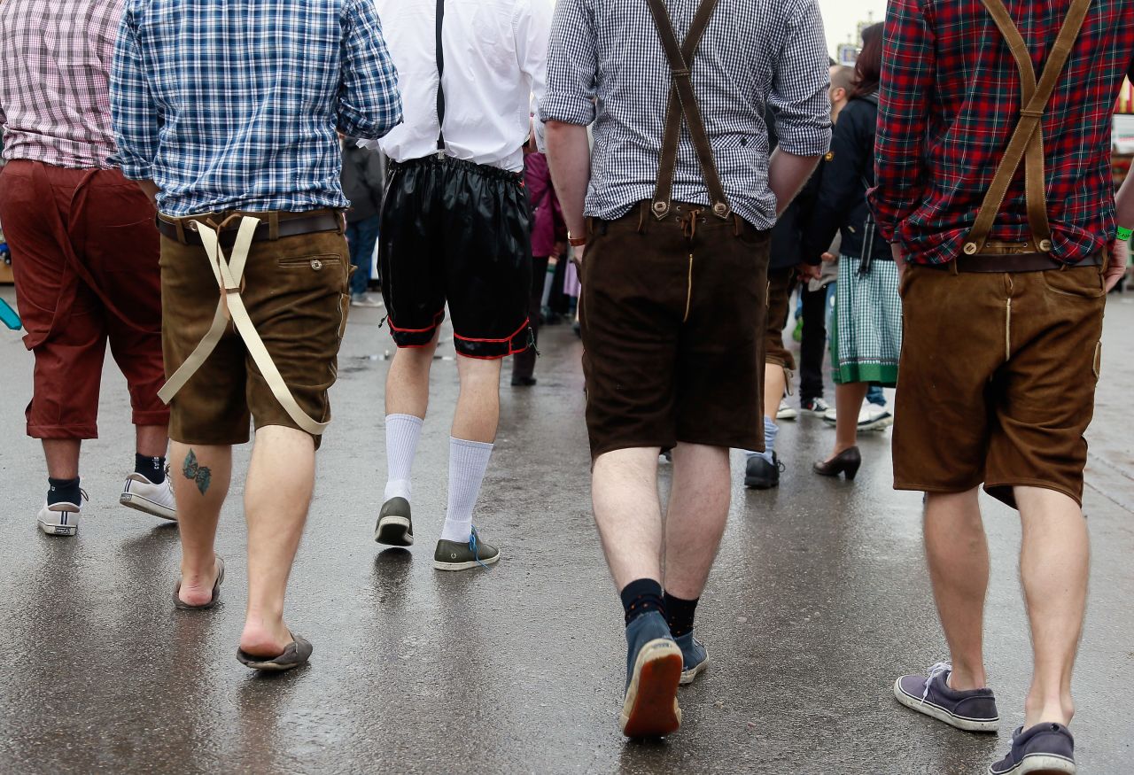 Revelers wearing different types of mock lederhosen walk at the festival.