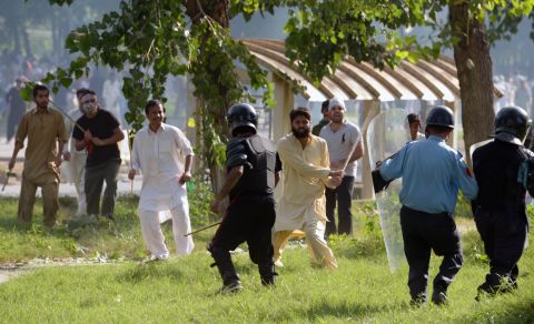 Pakistani Muslim demonstrators clash with police Friday during a protest near the U.S. consulate in Islamabad.