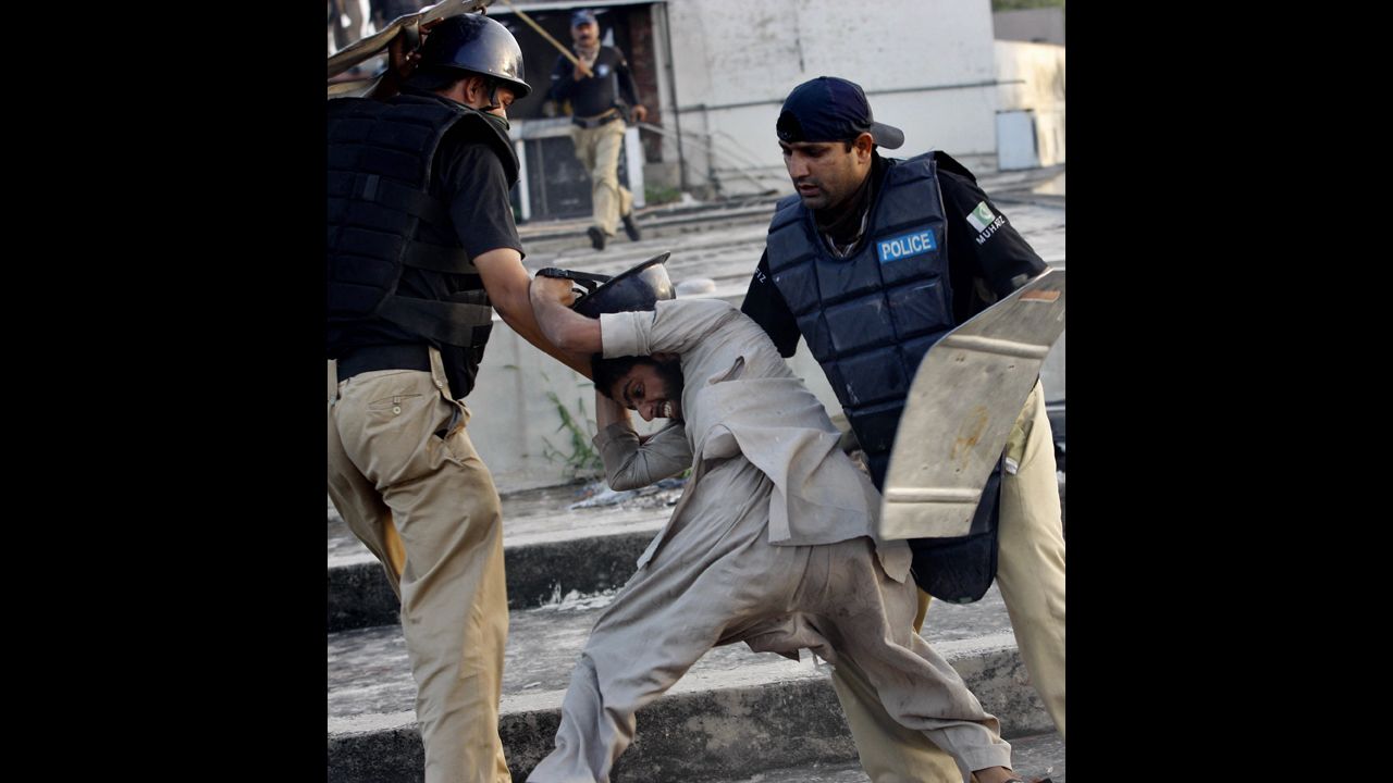 Pakistani police detain a demonstrator in Lahore on Friday during a protest against the film "Innocence of Muslims."