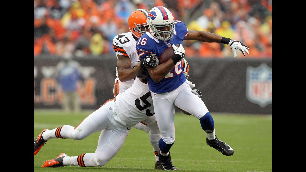 Brad Smith of the Buffalo Bills runs by Cleveland Browns defenders.