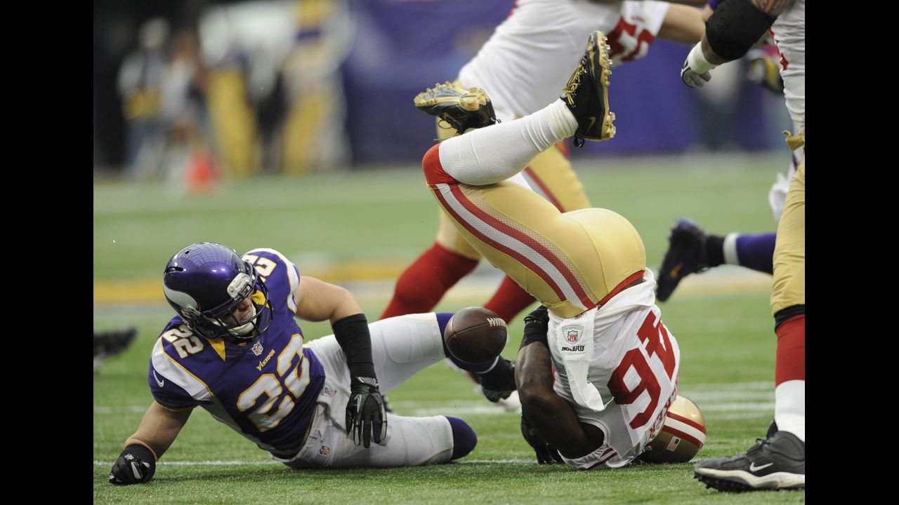Harrison Smith of the Minnesota Vikings tackles Delanie Walker of the San Francisco 49ers during the first quarter Sunday.