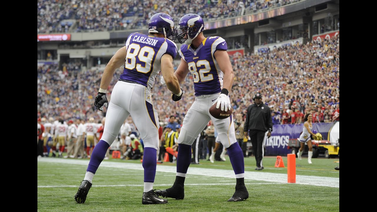 Minnesota's Kyle Rudolph, right, celebrates with John Carlson after scoring a touchdown against San Francisco.