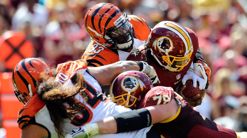 Quarterback Robert Griffin III of the Washington Redskins is sacked by No. 93 Michael Johnson of the Cincinnati Bengals.