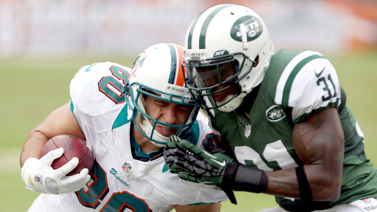 Anthony Fasano of the Miami Dolphins is tackled by Antonio Cromartie of the New York Jets at Sun Life Stadium in Miami Gardens, Florida.