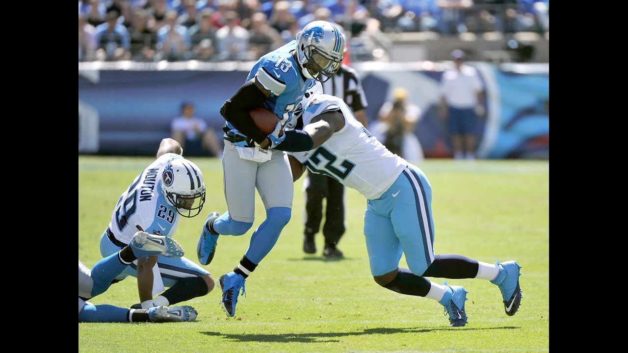 Nate Burleson of the Detroit Lions is tackled by Will Witherspoon of the Tennessee Titans on Sunday in Nashville.