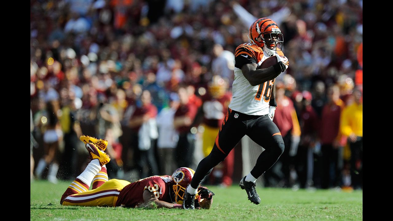 Andrew Hawkins of the Cincinnati Bengals avoids a tackle by the Washington Redskins' Richard Crawford on his way to scoring a game-winning touchdown Sunday in Landover, Maryland. The Bengals won 38-31.
