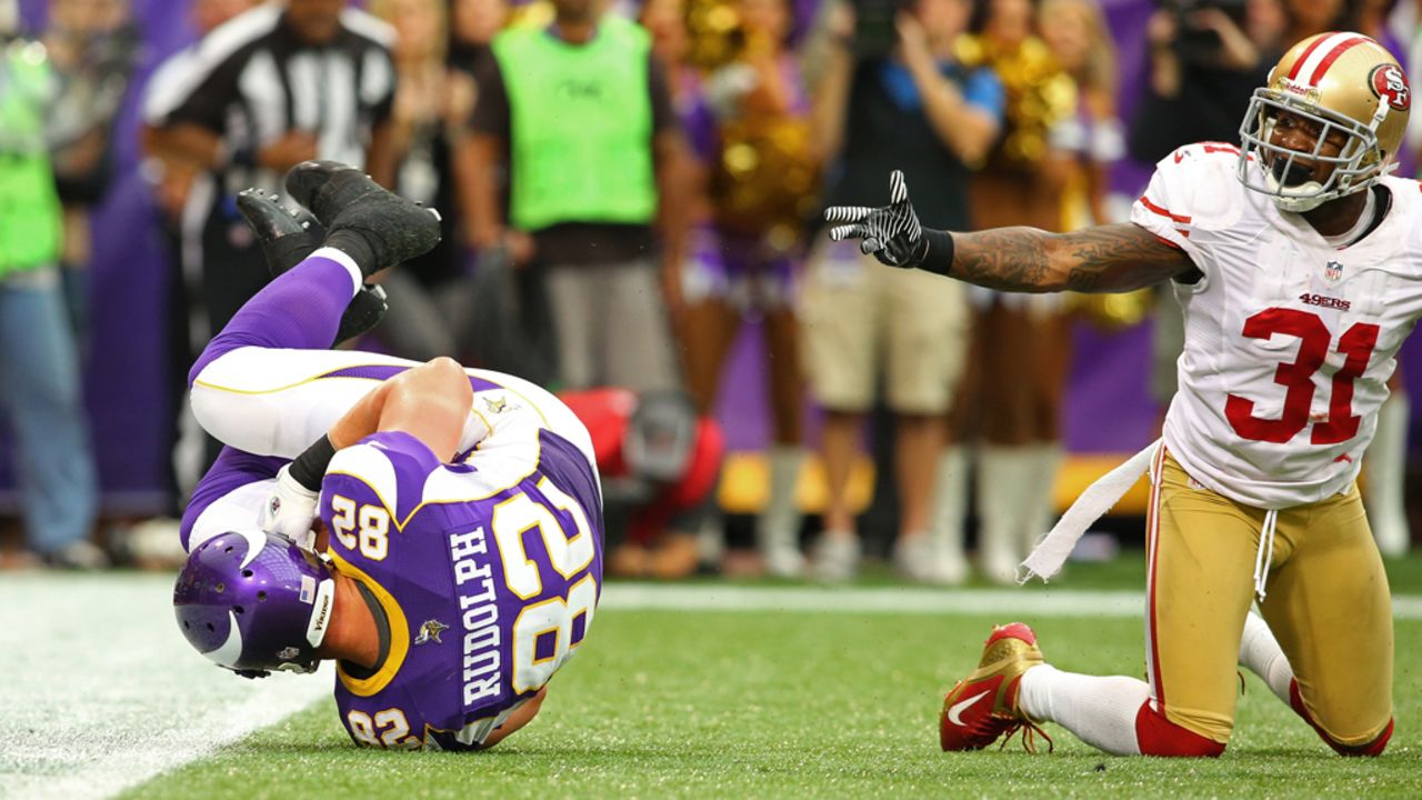 Kyle Rudolph of the Minnesota Vikings rolls in the endzone for a touchdown Sunday while Donte Whitner of the San Francisco 49ers looks to the referee.