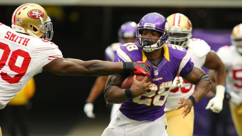 Aldon Smith of the 49ers attempts to snag the ball from Adrian Peterson of the Vikings on Sunday.