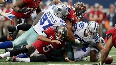 No. 5 Josh Freeman of the Tampa Bay Buccaneers fumbles the ball during Sunday's game against the Dallas Cowboys.