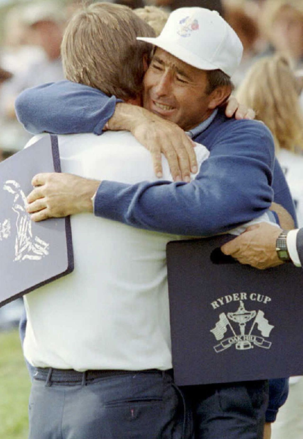 A tearful Ballesteros hugs arch-rival Nick Faldo after the Englishman scored a crucial victory over Curtis Strange as Europe won the 1995 match at Oak Hill.
