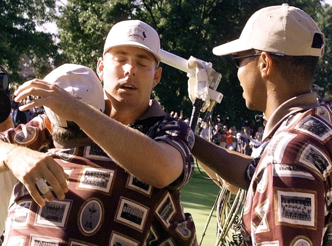 Justin Leonard is hugged by his teammates after beating Jose Maria Olazabal at the infamous match at Brookline in 1999. Olazabal had yet to make his putt to keep their singles clash alive when the U.S. team dashed onto the 17th green. 
