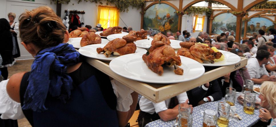 A woman serves Hendl at the Theresienwiese Oktoberfest fairgrounds on Monday.