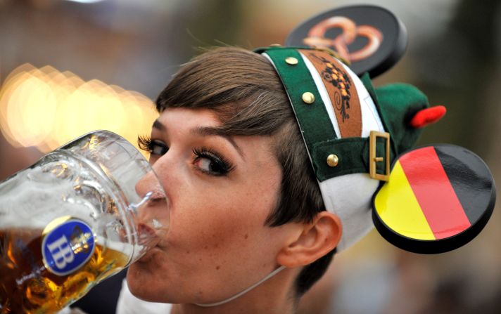 A young woman drinks beer at the Oktoberfest beer festival on Monday, September 24. 