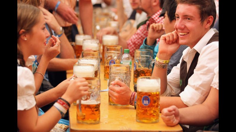 Revelers dressed in traditional Bavarian clothes celebrate at Schottenhamel beer tent on Saturday, September 22.