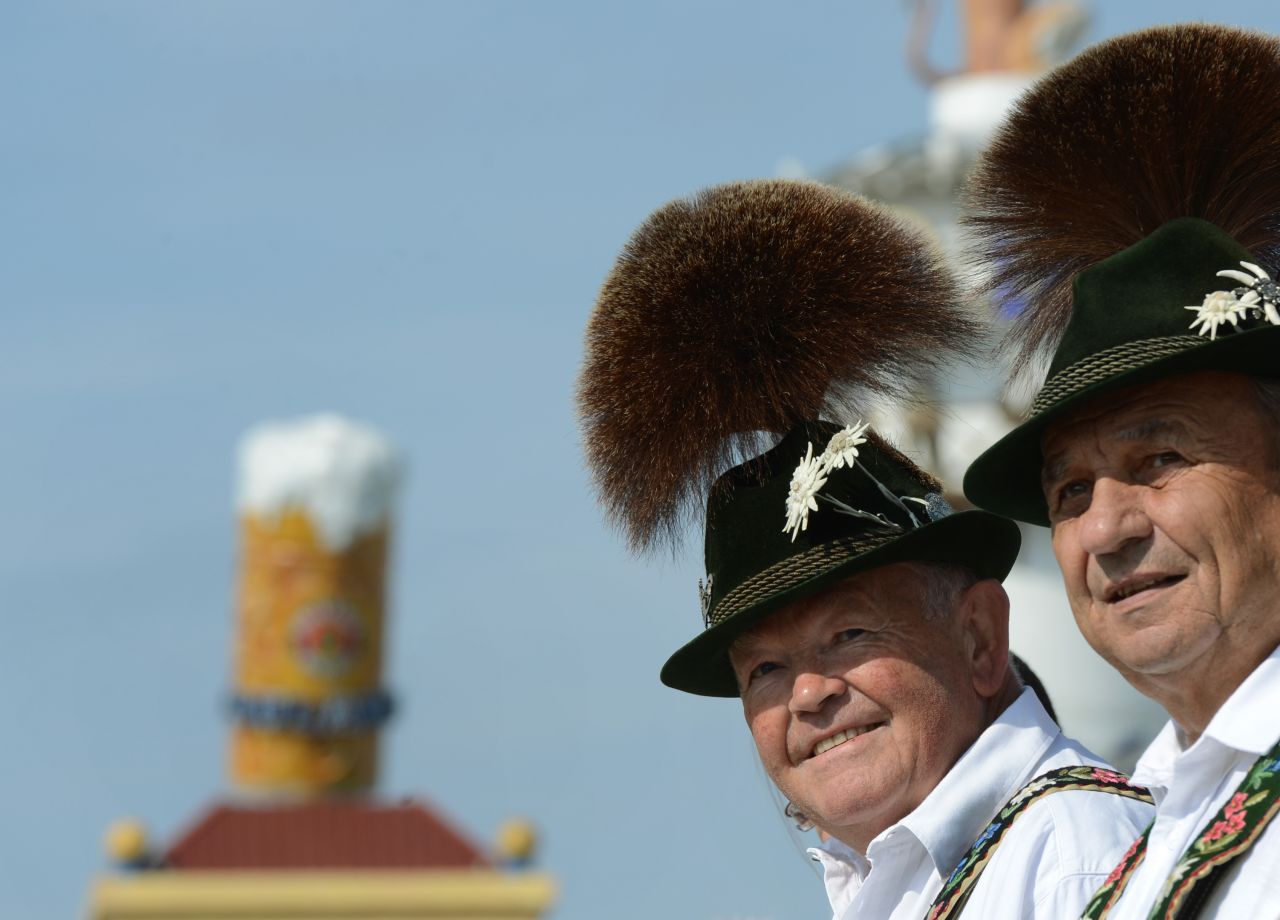 Two men wearing traditional Bavarian clothes take part in the costumes and riflemen parade on Sunday.