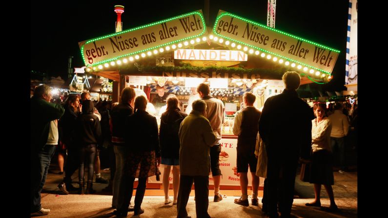 A booth selling fried nuts attracts people evening on Saturday evening.