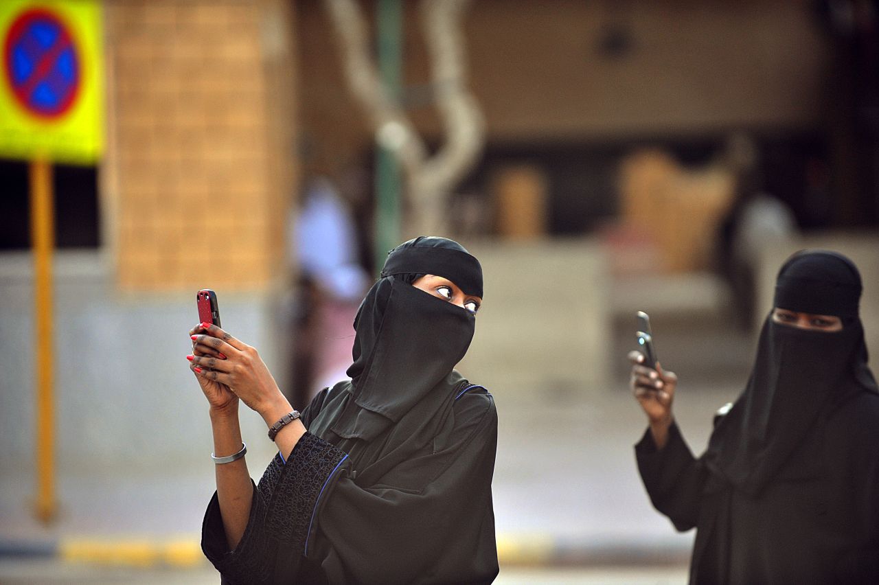 These Saudi women are taking photos with their mobile phones after the end of a prayer performed on the first day of Eid al-Fitr in the great mosque in the old City of Riyadh to mark the end of the holy fasting month of Ramadan. 