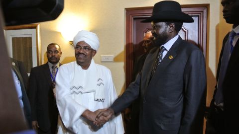 Sudanese President Omar Al Bashir, left, shakes hands with South Sudanese President Salva Kiir following a meeting in July.