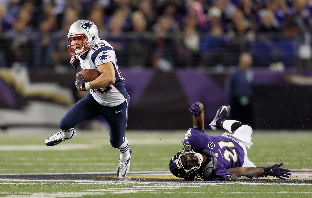 Wes Welker of the New England Patriots runs with the ball after catching a pass in front of Lardarius Webb of the Baltimore Ravens in Baltimore on Sunday, September 23. The Ravens won 31-30.