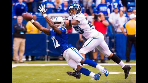 Donnie Avery of the Indianapolis Colts reaches out for a catch that fell incomplete as Dwight Lowery of the Jacksonville Jaguars defends Sunday in Indianapolis.