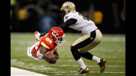 Dwayne Bowe of the Kansas City Chiefs is pushed out of bounds by Patrick Robinson of the New Orleans Saints on Sunday in New Orleans. The Chiefs defeated the Saints 27-24 in overtime.