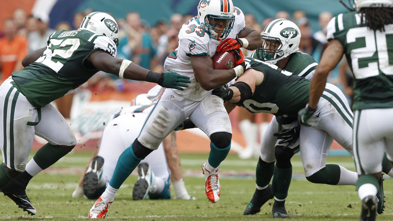 Daniel Thomas of the Miami Dolphins runs with the ball during Sunday's game against the New York Jets at Sun Life Stadium in Miami Gardens, Florida. The Jets defeated the Dolphins 23-20 in overtime.
