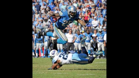 Mikel LeShoure of the Detroit Lions jumps over Ryan Mouton of the Tennessee Titans.