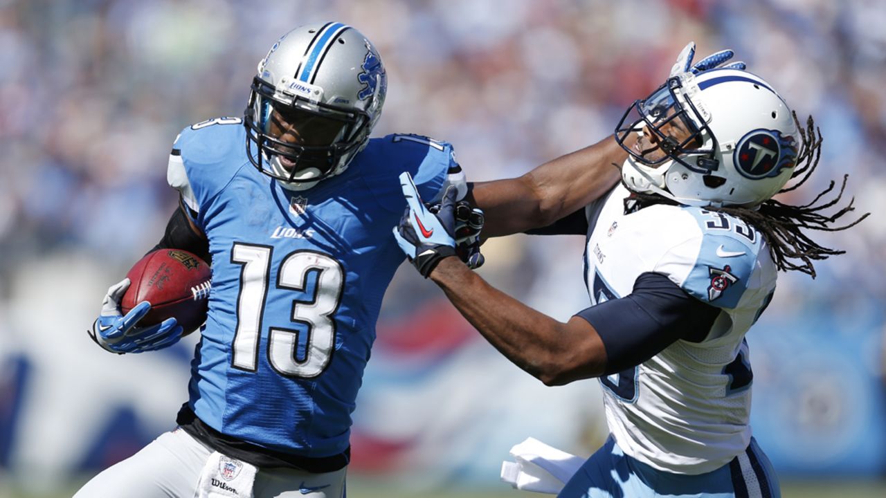 Nate Burleson of the Lions stiff-arms Michael Griffin of the Titans.
