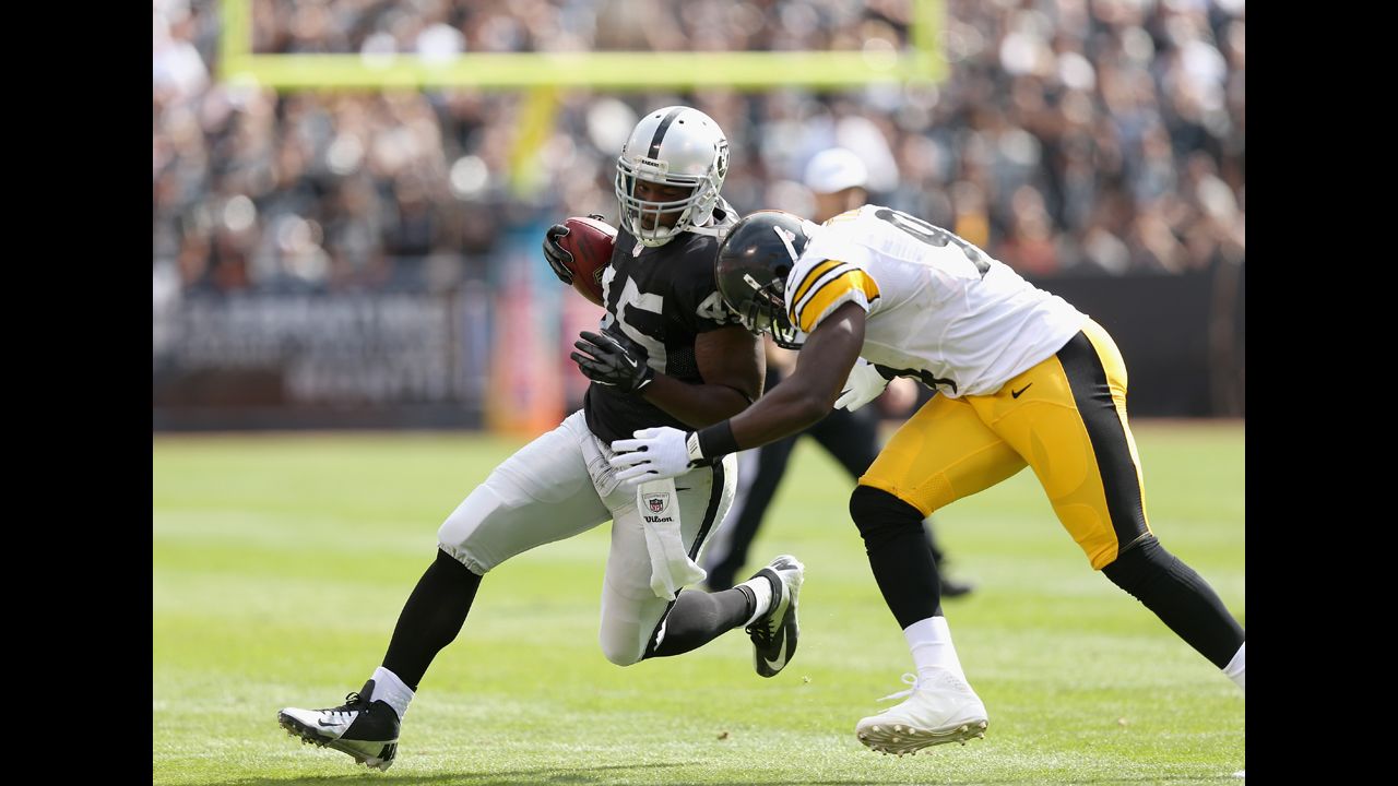 Oakland's Marcel Reece is hit by Pittsburgh's Lawrence Timmons.