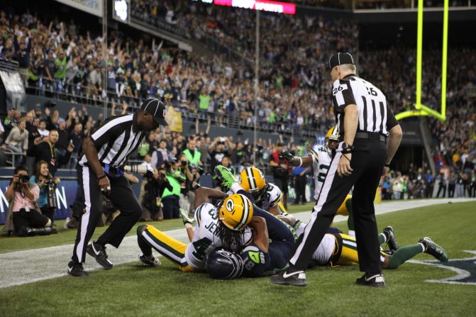 Referees rush over to make the call.