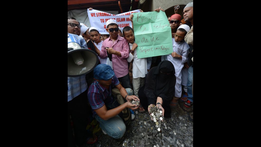 Philippine Muslims gather coins they collected from the provinces to be used to pay for filing a petition before the Philippine Supreme Court in Manila on Monday asking for local authorities to ban the controversial "Innocence of Muslims" film from being posted on the Internet.  Hundreds of Muslim protesters in the Philippines called for a ban on the film before the U.S. Embassy.