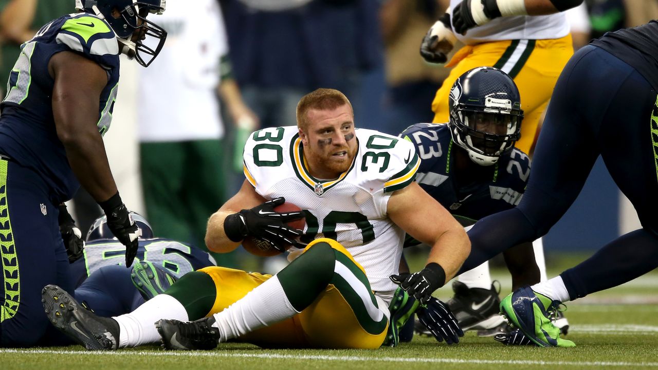 John Kuhn of Green Bay looks around after losing his helmet on a play.