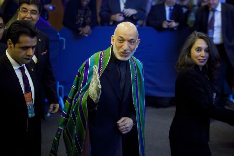 Afghan President Hamid Karzai, center, arrives on Tuesday.