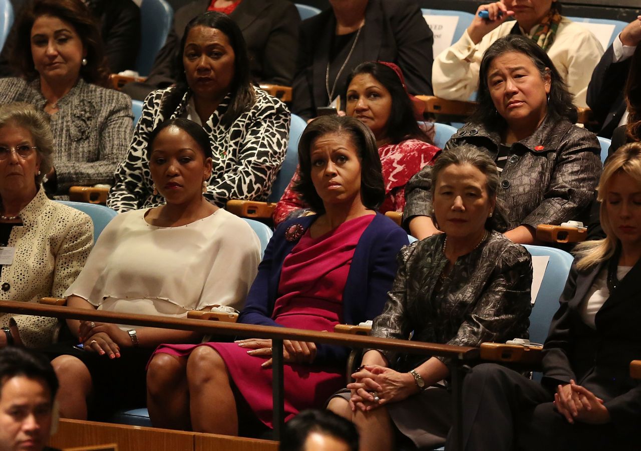 U.S. first lady Michelle Obama, center, listens to her husband speak on Tuesday.