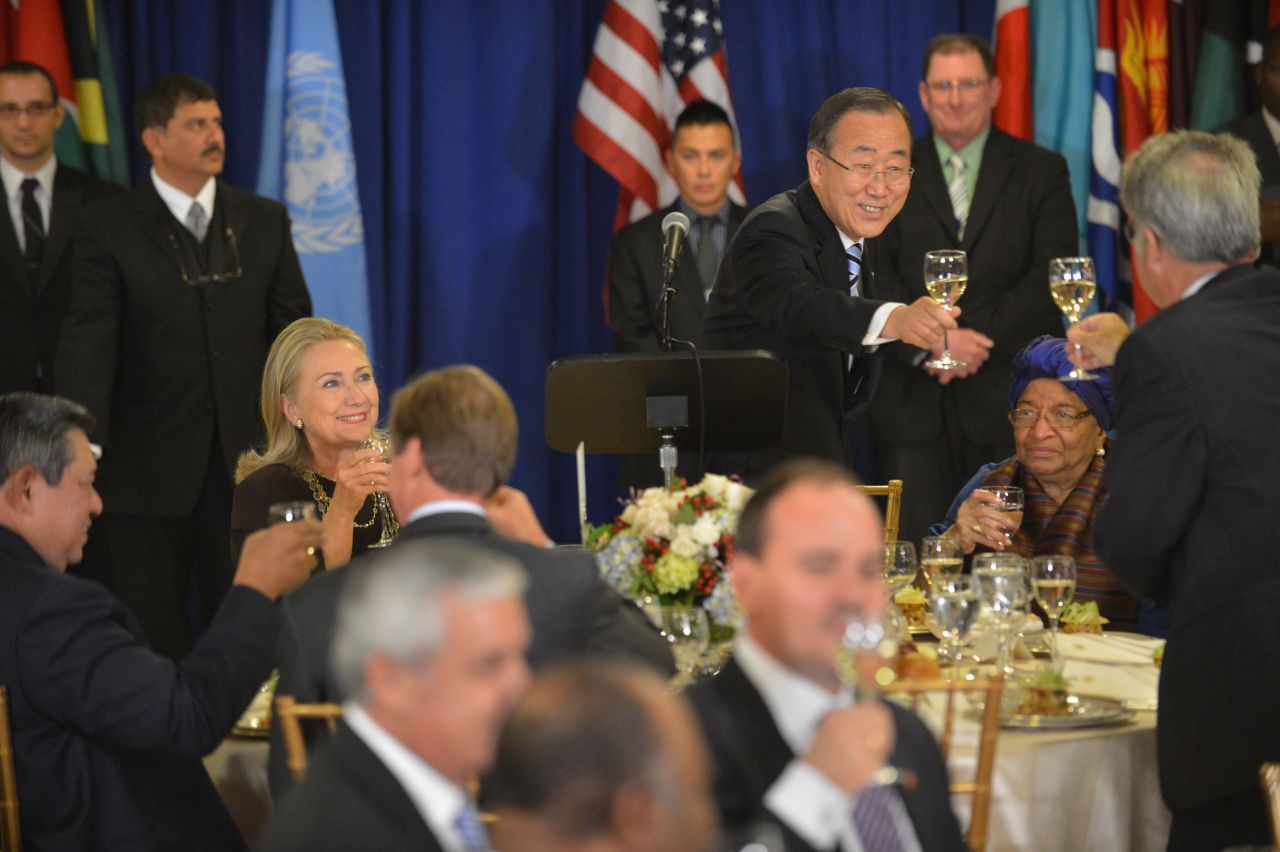 United Nations Secretary-General Ban Ki-moon, standing, makes a toast during a luncheon on Tuesday as U.S. Secretary of State Hillary Clinton, left, looks on.